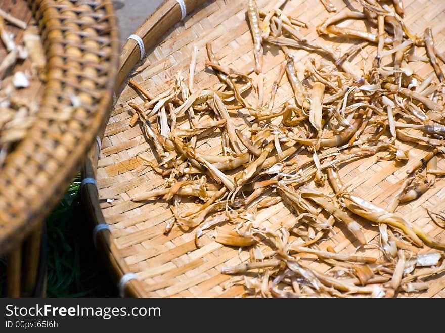 Mysterious spices being dried up in the sun on bamboo platforms