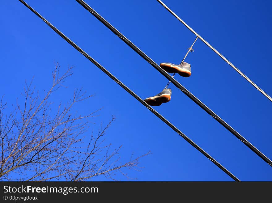 Hanging shoes on electrical wire. Hanging shoes on electrical wire