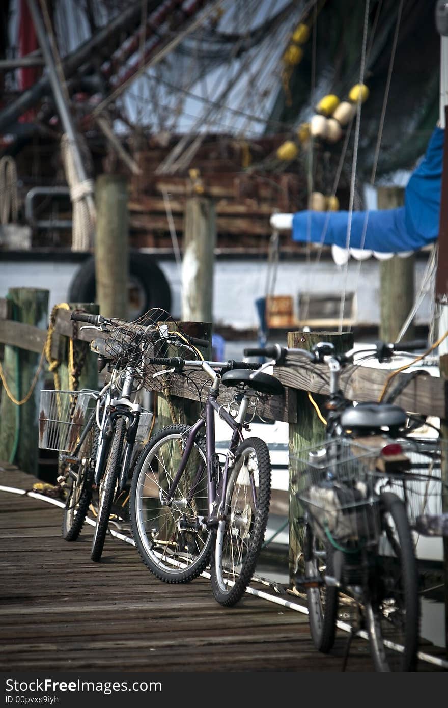 Bikes lined up and leaning on the railing