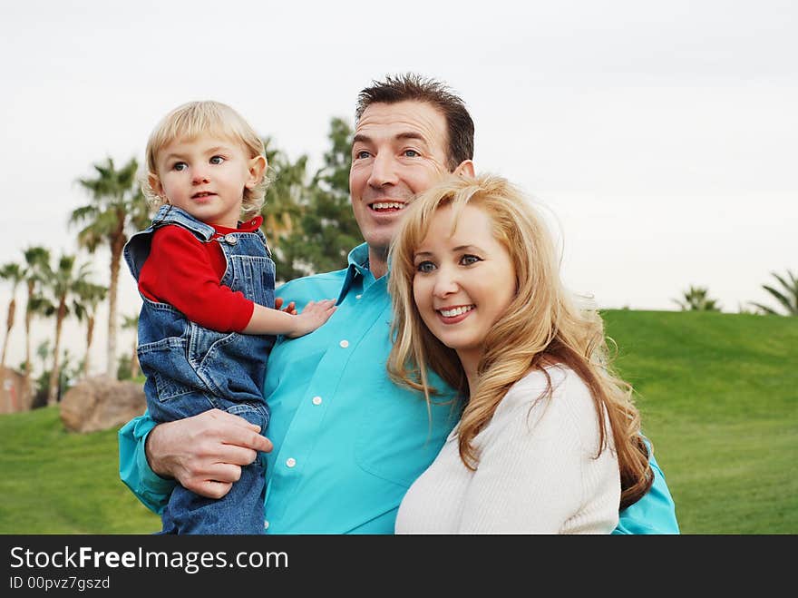 Happy couple with a child smiling and enjoying their time together