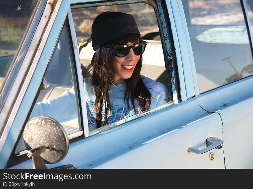 Young punk woman with car troubles