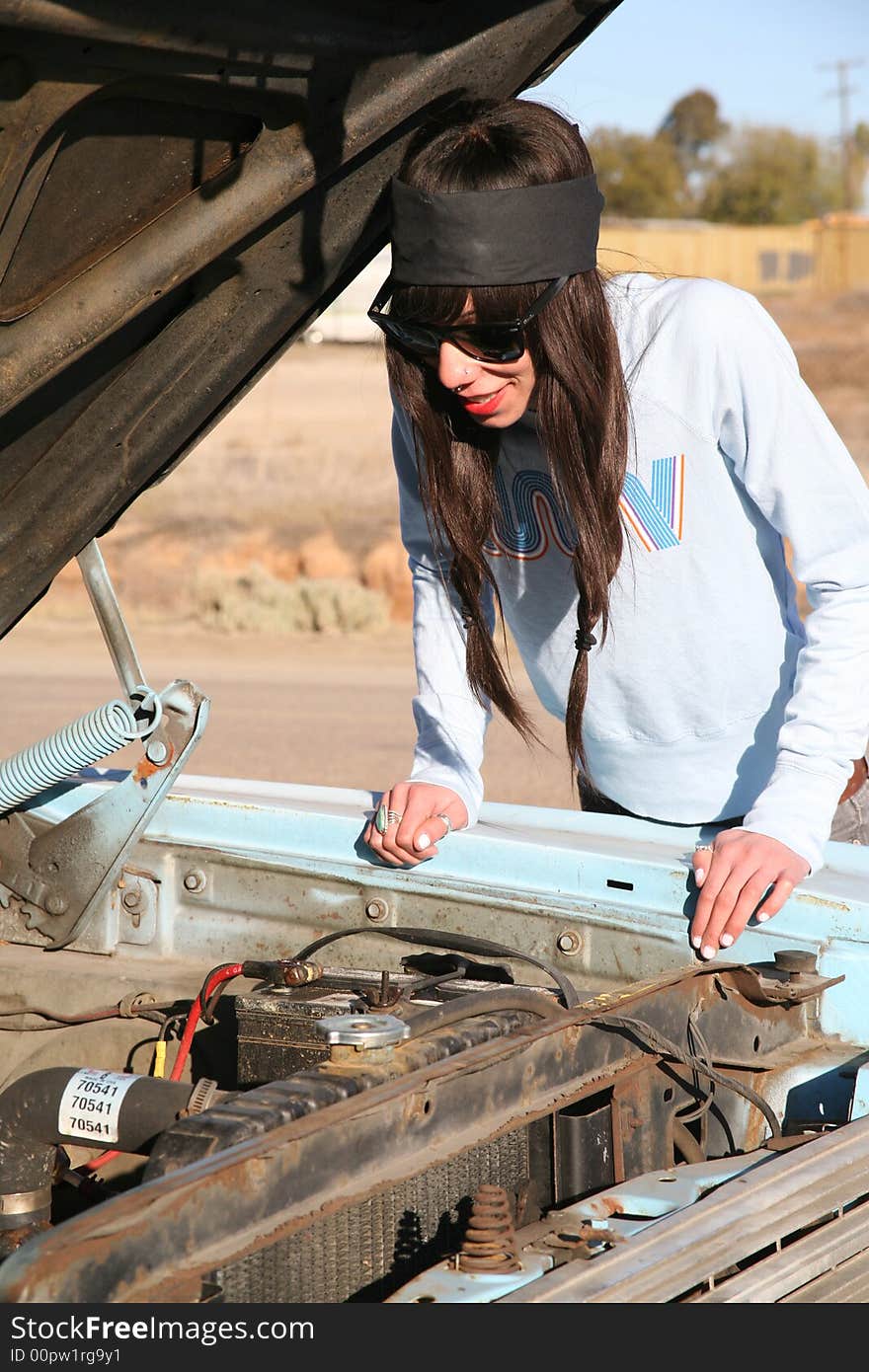 Young, tall, brown-eyed woman having car problems. Young, tall, brown-eyed woman having car problems