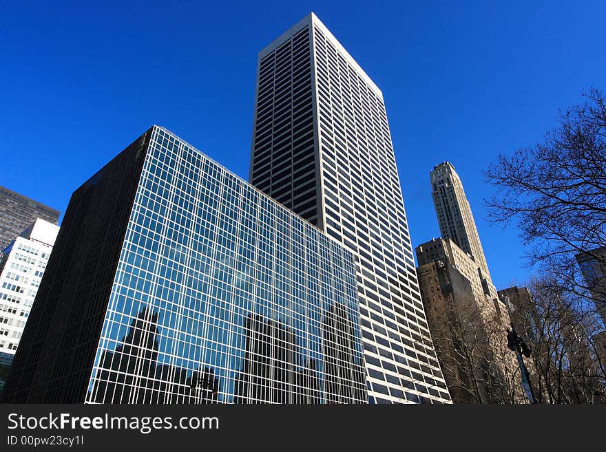 Reflective corporate buildings on a clear day in manhattan. Reflective corporate buildings on a clear day in manhattan