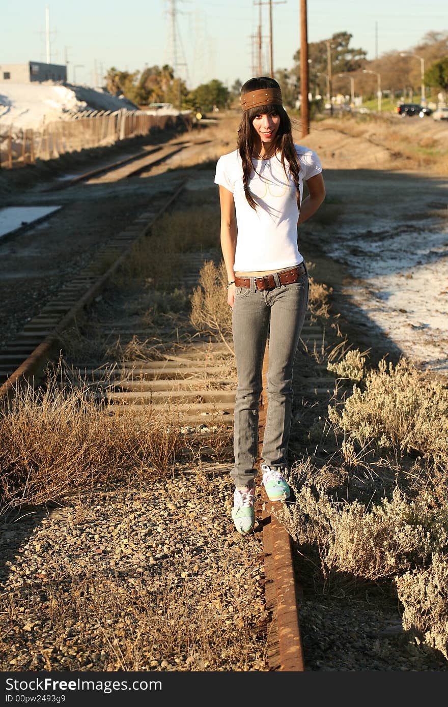 Young, tall, brown-eyed woman on the railroad tracks. Young, tall, brown-eyed woman on the railroad tracks