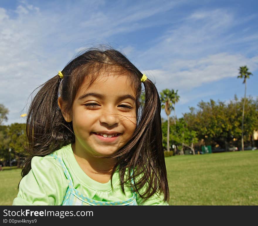 Girl Smiling while outside at the park. Girl Smiling while outside at the park