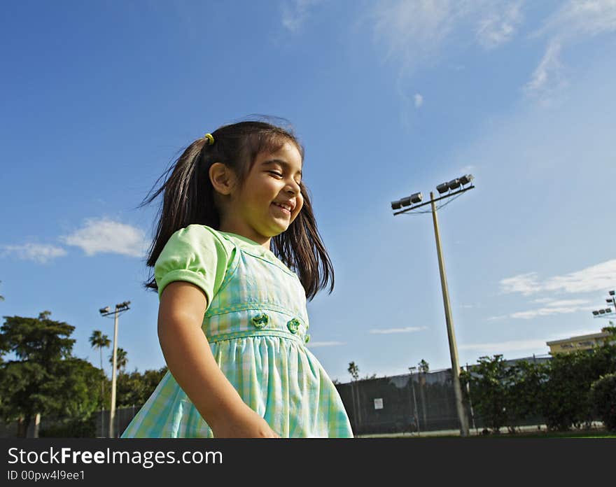 Girl Walking through a park. Blue sky background. Girl Walking through a park. Blue sky background