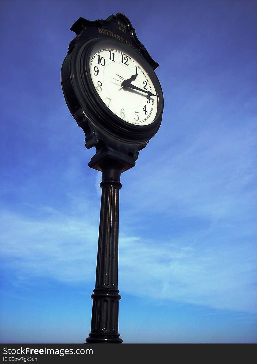 Black Antique clock against a blue sky. Black Antique clock against a blue sky