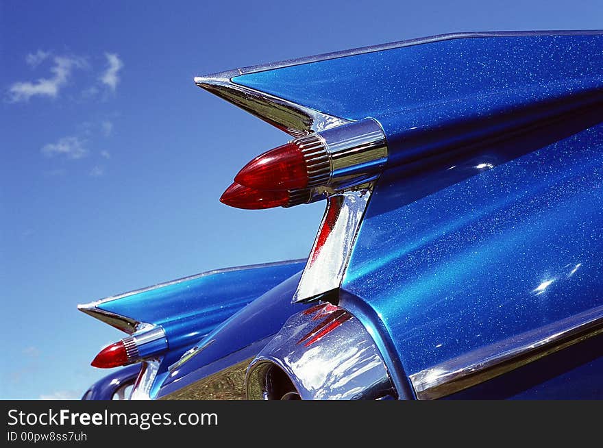 Tail lights and wings against blue sky. Tail lights and wings against blue sky