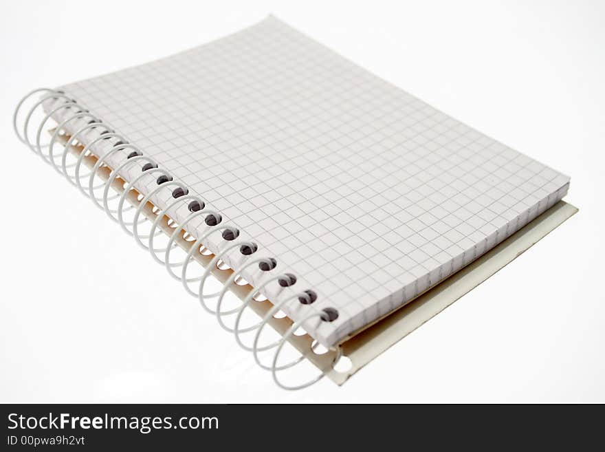 Office - spiral notebook over white.