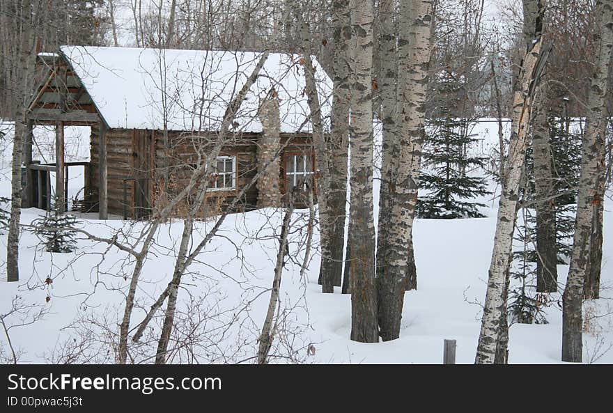 A cozy and romantic log cabin hidden away in the winter forest. A cozy and romantic log cabin hidden away in the winter forest