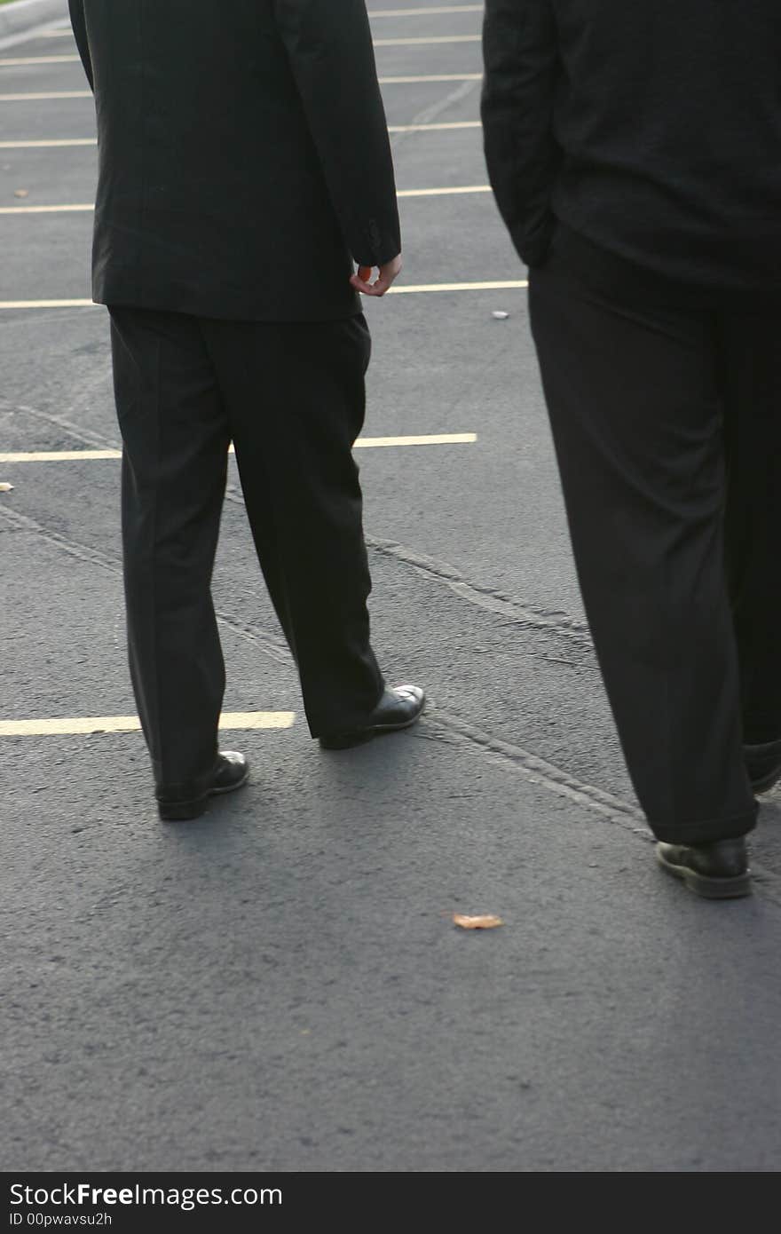 Two business men walking in parking lot. Two business men walking in parking lot