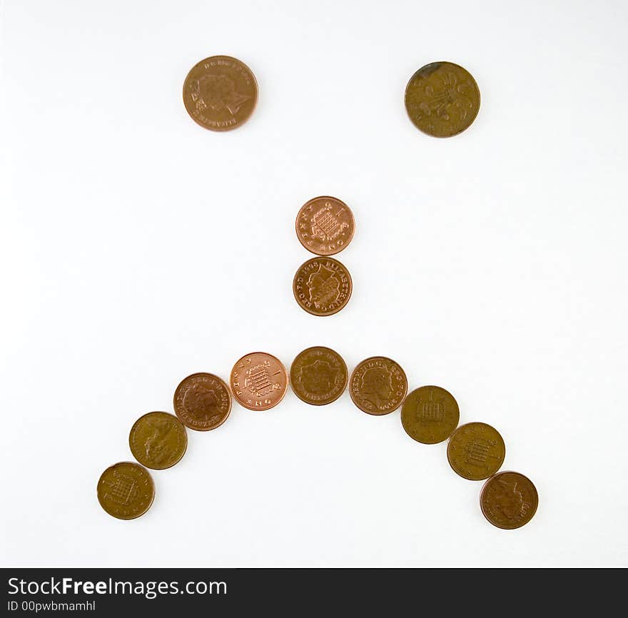 Simple 'sad' emoticol symbol made of one penny coins. Simple 'sad' emoticol symbol made of one penny coins