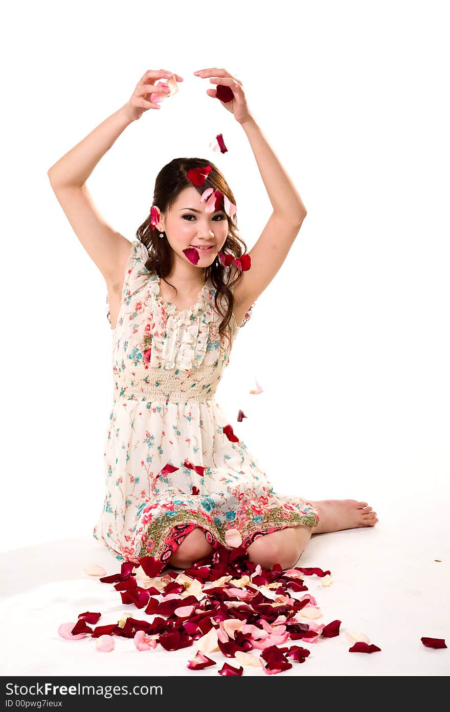 A very happy and joyfull girl tossing rose petals in the air. A very happy and joyfull girl tossing rose petals in the air