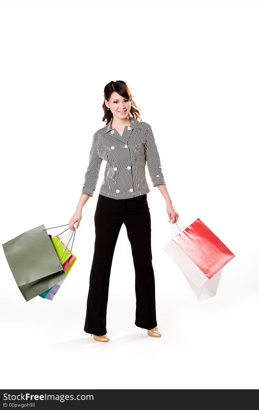 Young woman happily shopping full of paper bags. Young woman happily shopping full of paper bags