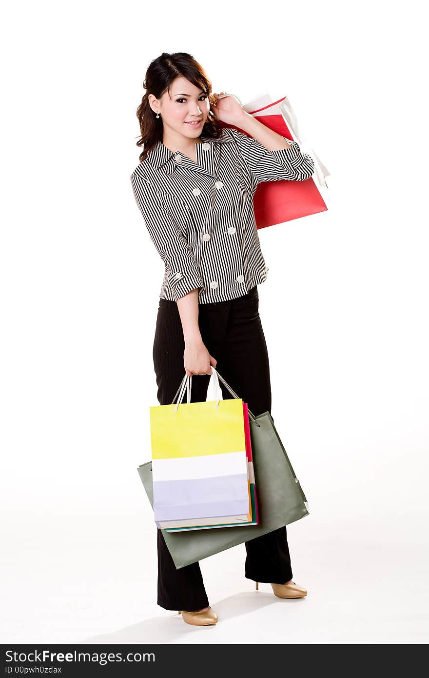 Young woman happily shopping full of paper bags. Young woman happily shopping full of paper bags