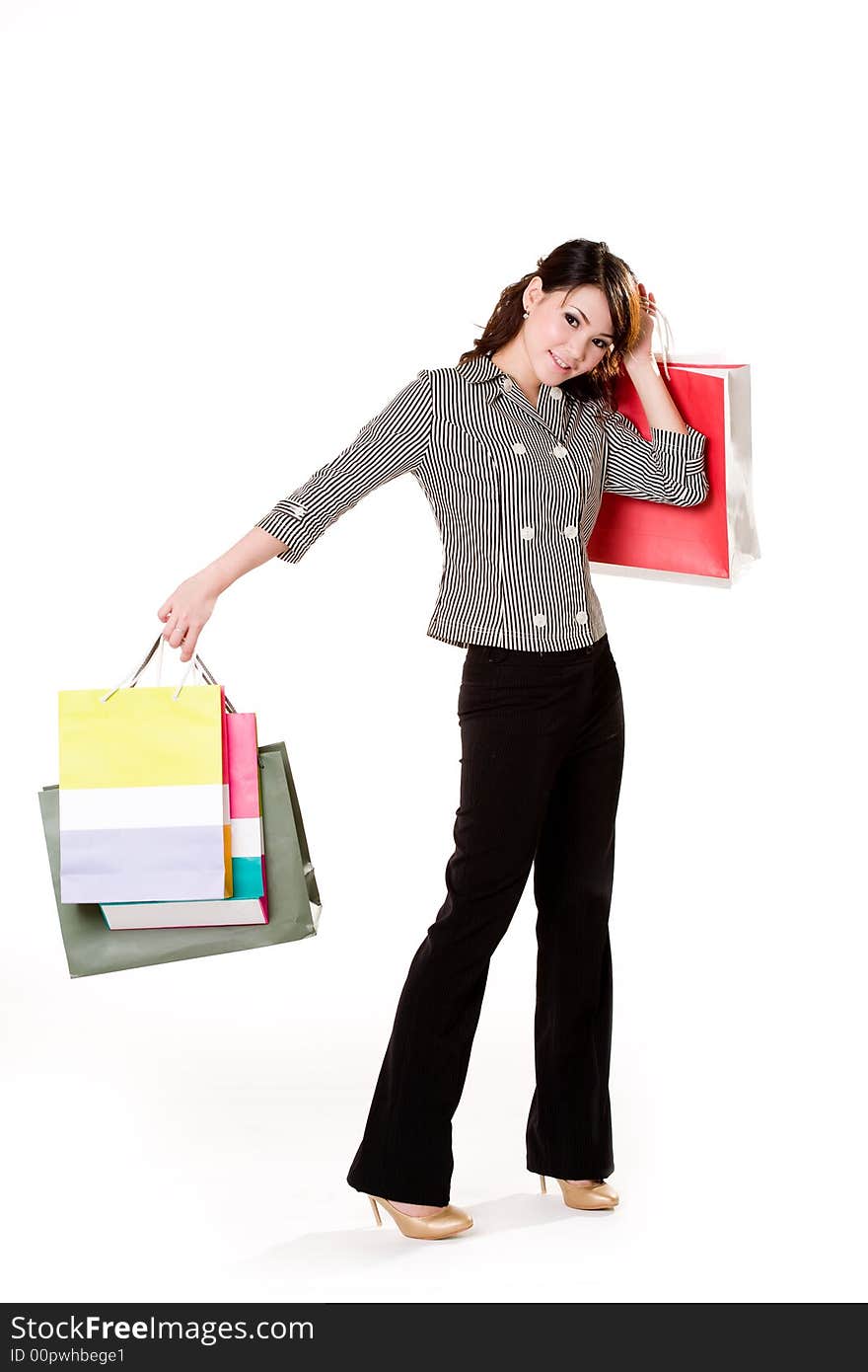 Young woman happily shopping full of paper bags. Young woman happily shopping full of paper bags