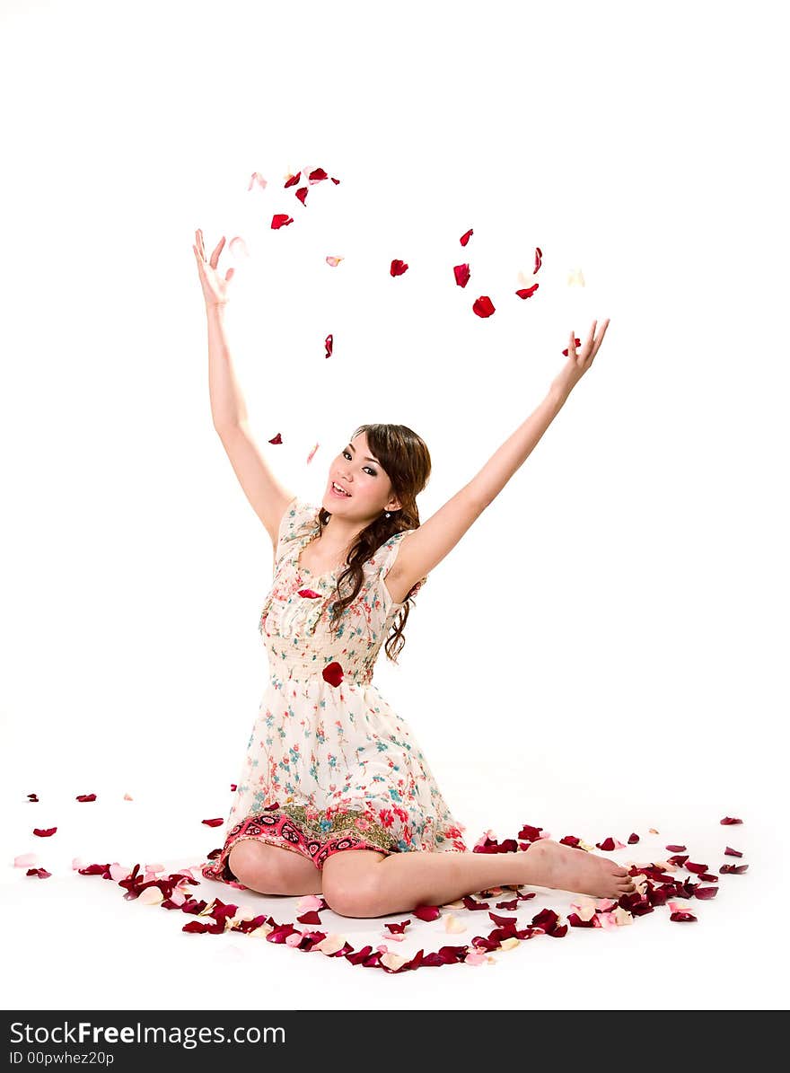 A very happy and joyfull girl tossing rose petals in the air. A very happy and joyfull girl tossing rose petals in the air