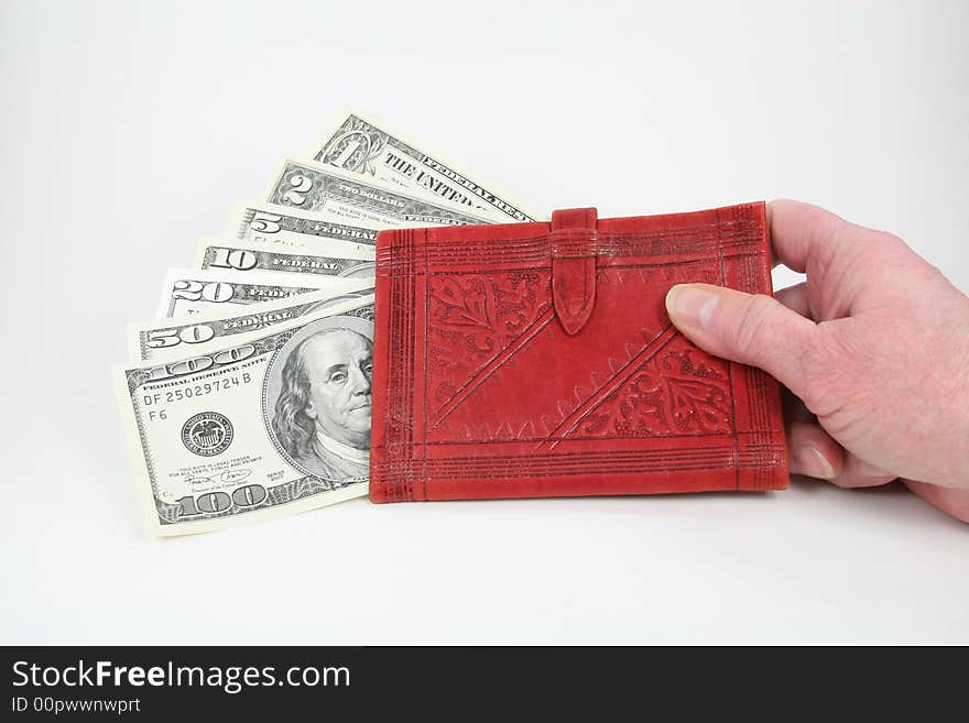 U.S. currency in a red wallet held in a hand. U.S. currency in a red wallet held in a hand.