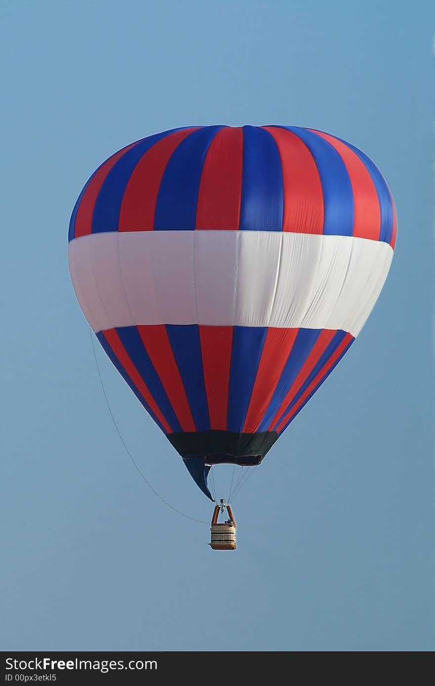 Red, white and blue, un-manned hot-air balloon flying.