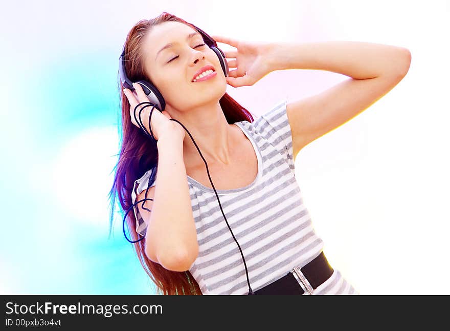 View of young  female listening music via earphones. Image may contain slight multicolor aberration as a part of design. View of young  female listening music via earphones. Image may contain slight multicolor aberration as a part of design.