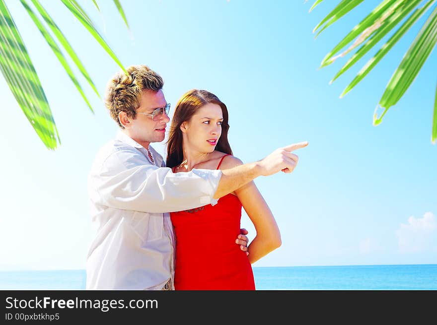 A portrait of attractive couple having date on the beach. A portrait of attractive couple having date on the beach