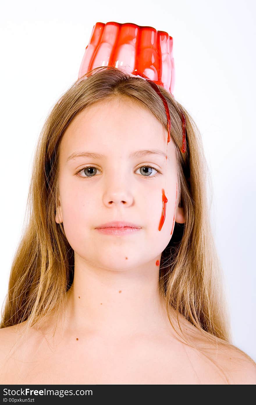 Blond child with desert on her head looking