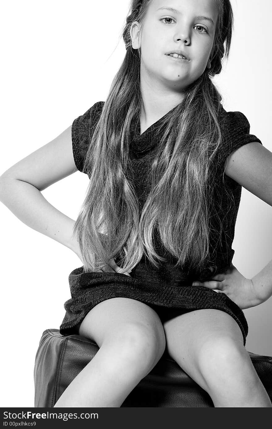 Studio portrait of a blond child sitting and posing. Studio portrait of a blond child sitting and posing