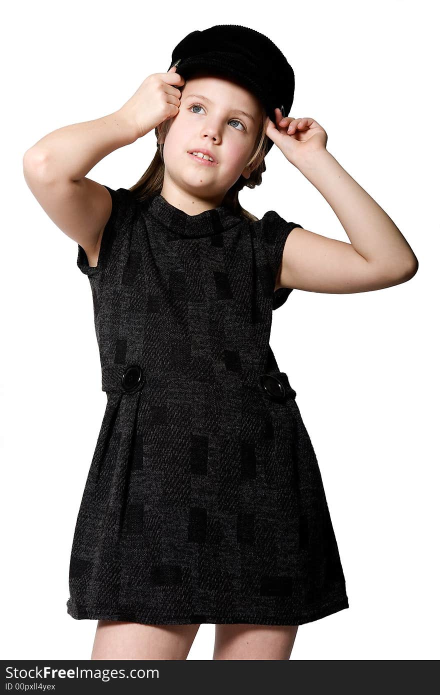 Studio portrait of a blond child in a black dress and hat. Studio portrait of a blond child in a black dress and hat