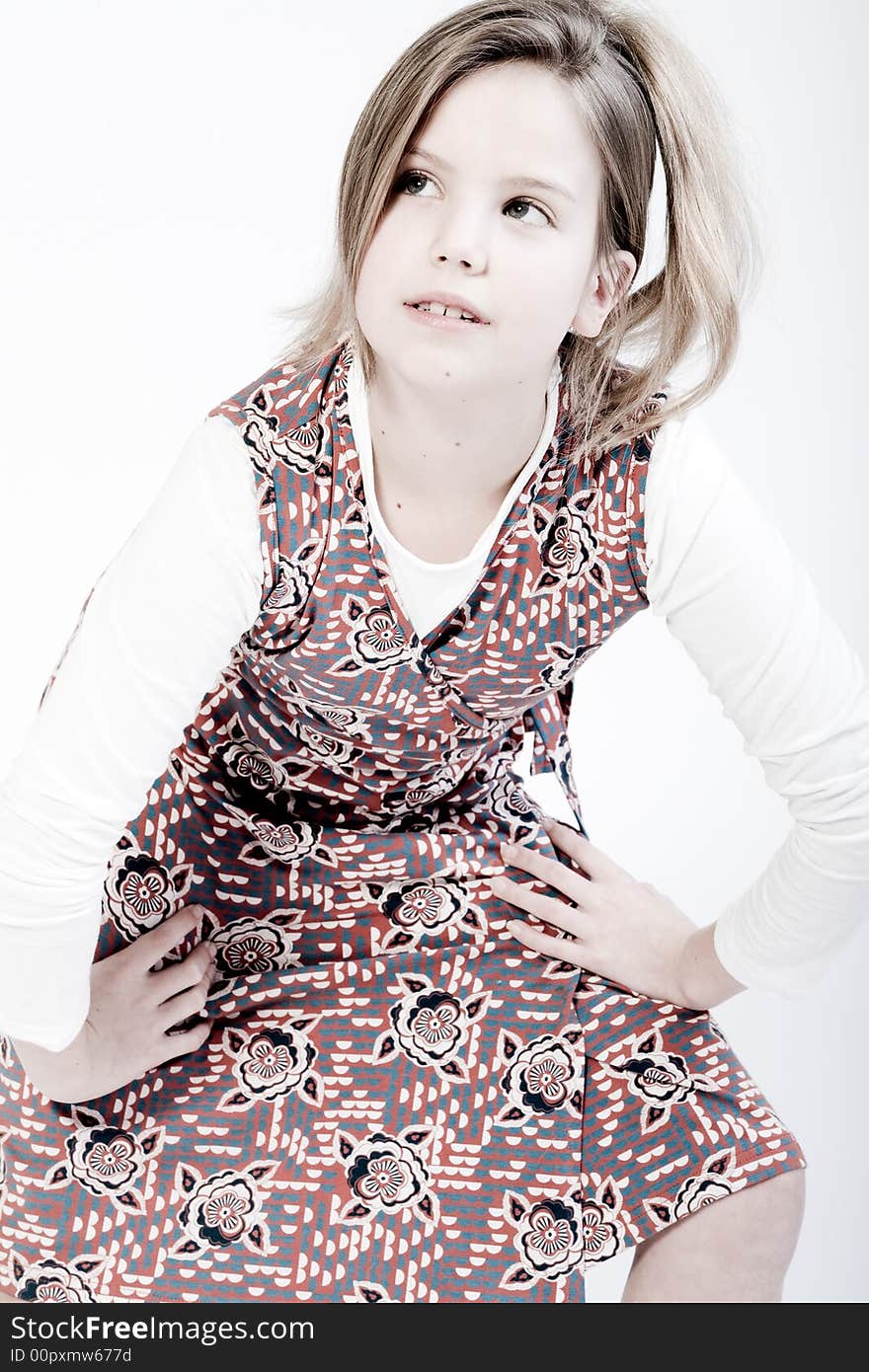 Studio portrait of a blond child looking up fashionably