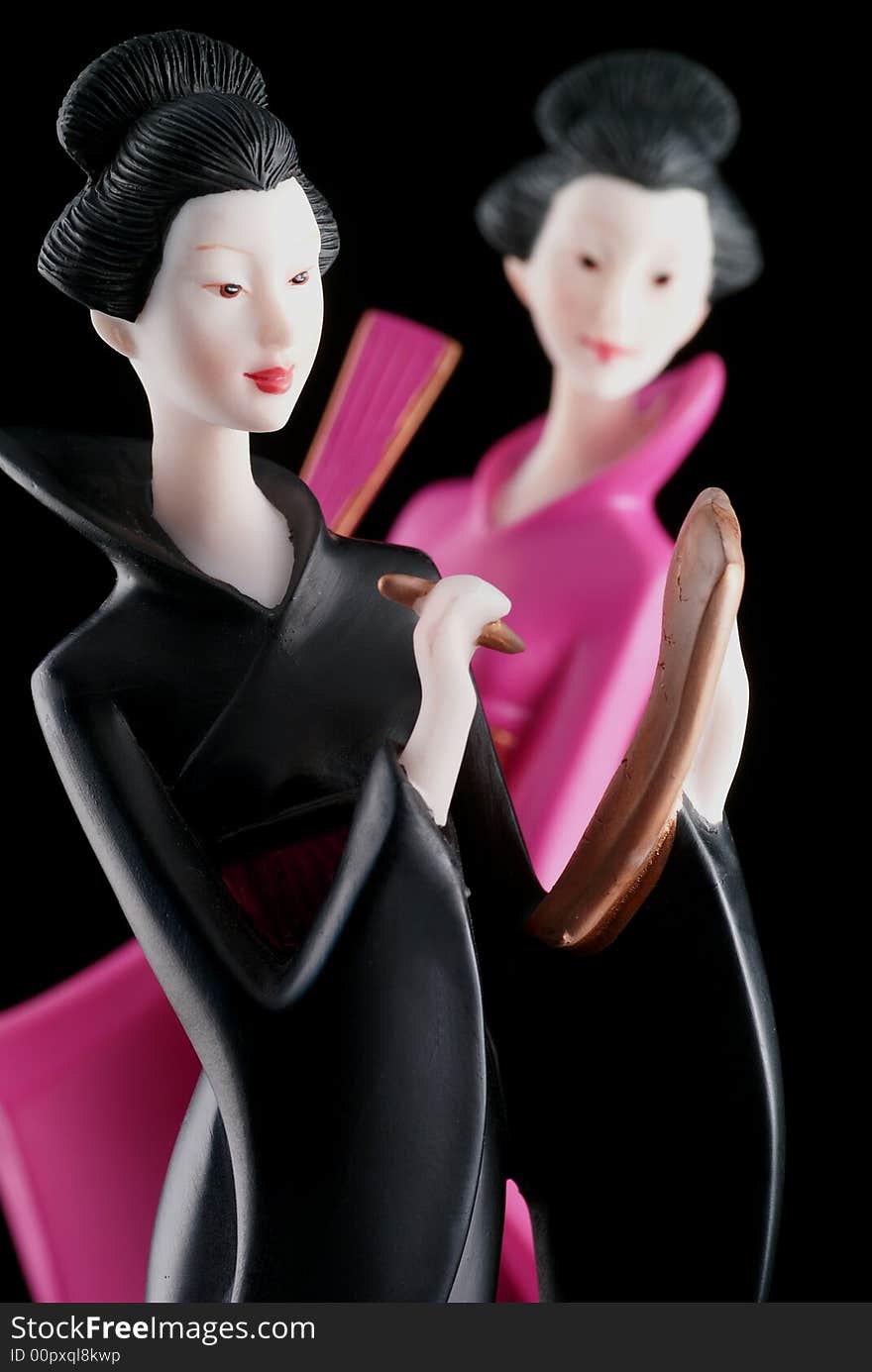 Two beautiful chinese ladies isolated on a black background. Two beautiful chinese ladies isolated on a black background.