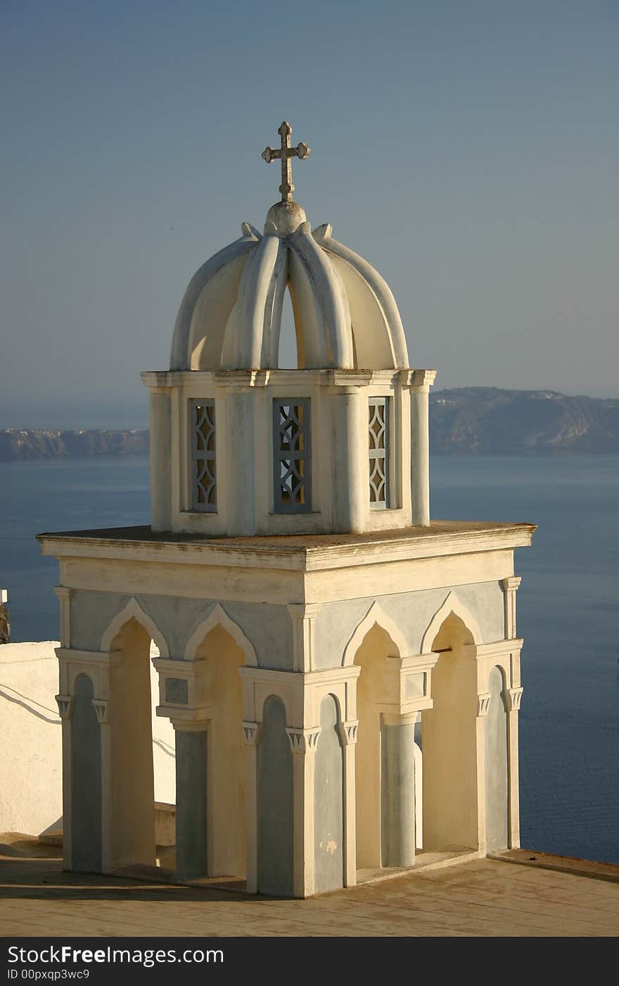 Church with cross at Santorini, Greece with bay in background. Church with cross at Santorini, Greece with bay in background