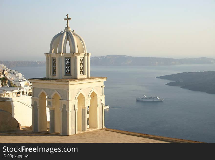 Church with cross at Santorini, Greece with bay in background with cruise ship. Church with cross at Santorini, Greece with bay in background with cruise ship