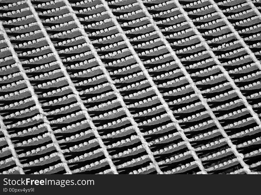 Steel grate with snow in an abstract pattern