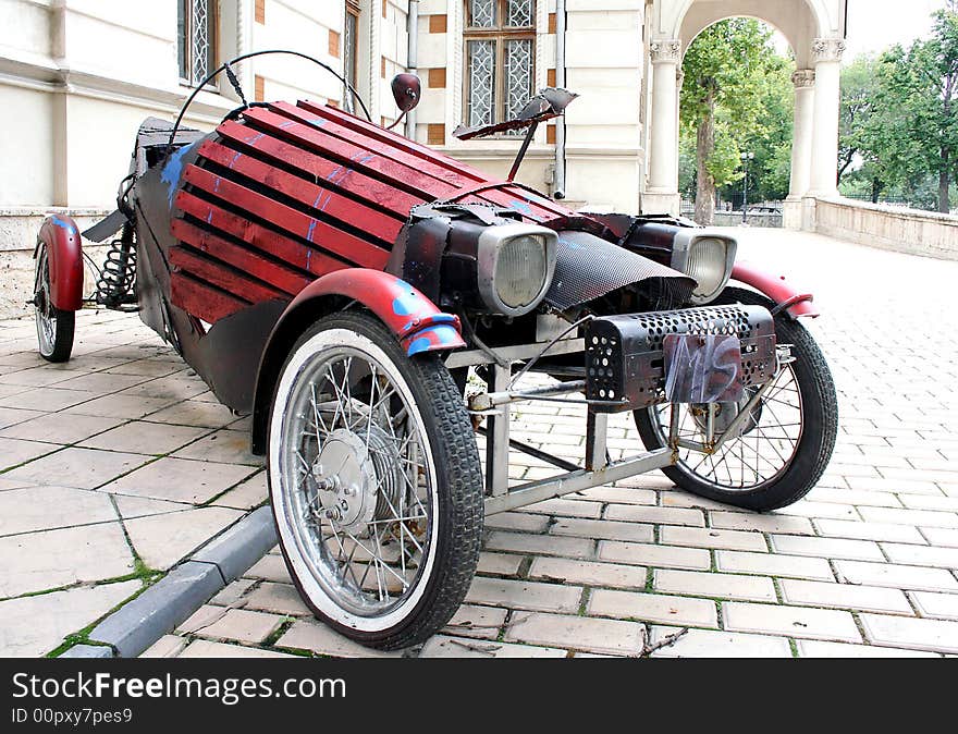 Old car reproduction parked near house