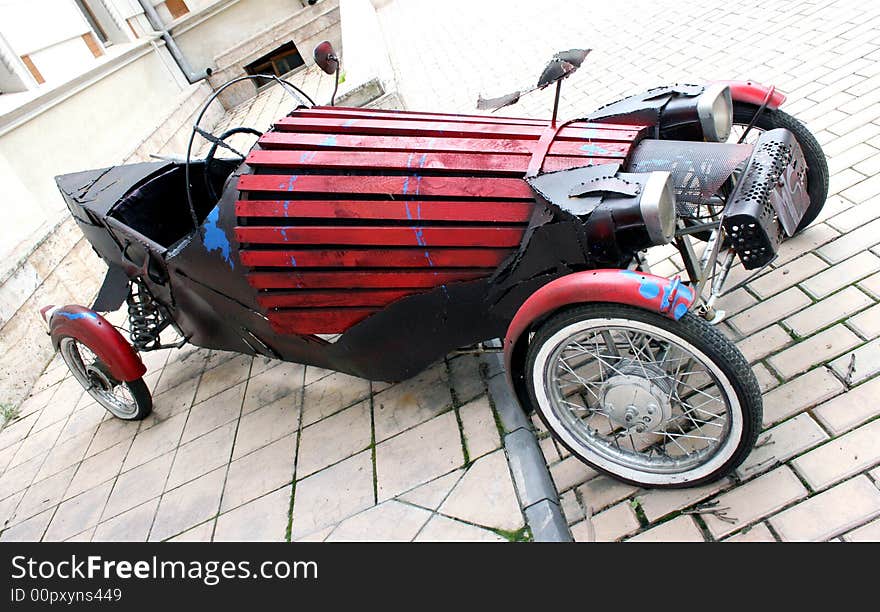 Old car reproduction parked near house