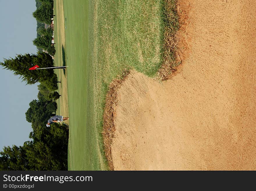 Putting Near Sand trap on golf course