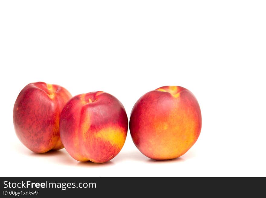 Three peaches isolated on white, one cut in health. Three peaches isolated on white, one cut in health