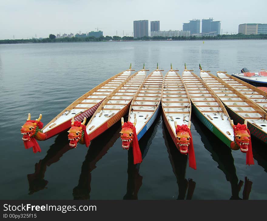 Dragon boats and buildings in a park