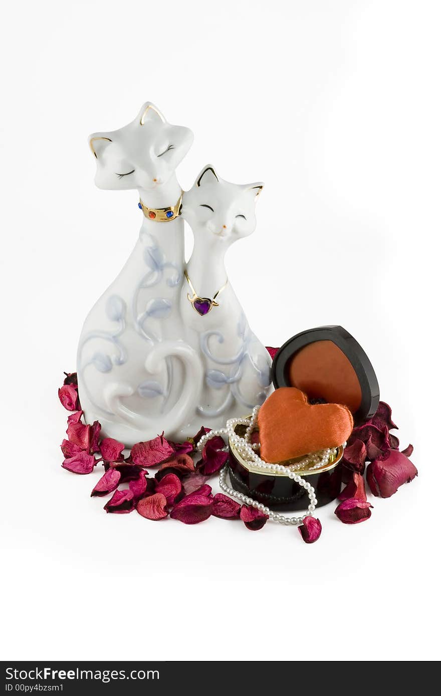 Two enamoured cats with a heart-shape casket and a thread of pearls. Isolated on white background. Clipping path included.