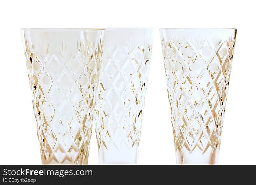 A glass beside a stack of white plates - on white background. A glass beside a stack of white plates - on white background