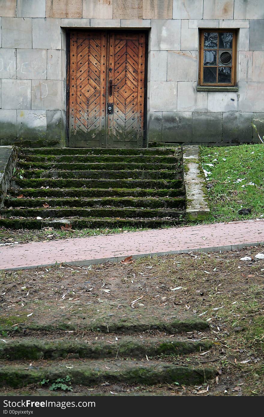 Dirty stairs covered with moss, old wooden door,. Dirty stairs covered with moss, old wooden door,