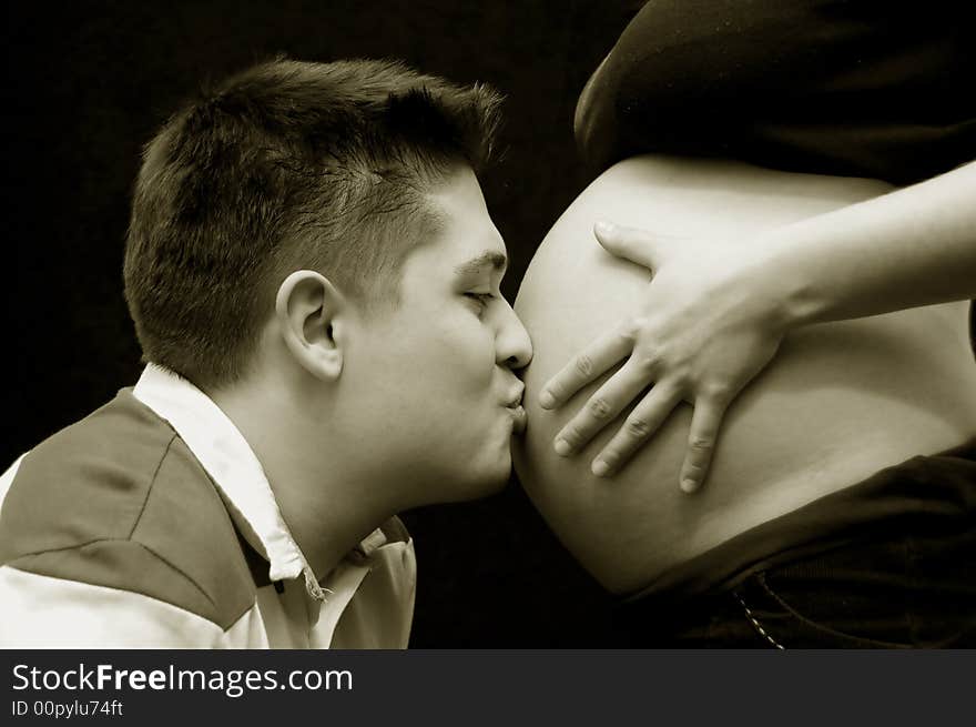 A view with a pregnant woman and her husband. Happy family. A view with a pregnant woman and her husband. Happy family