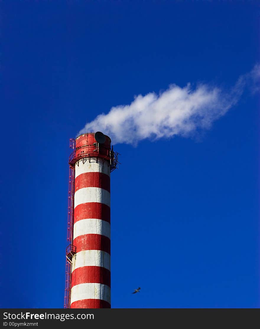 Heating plant chimney white smoke with blue sky. Heating plant chimney white smoke with blue sky