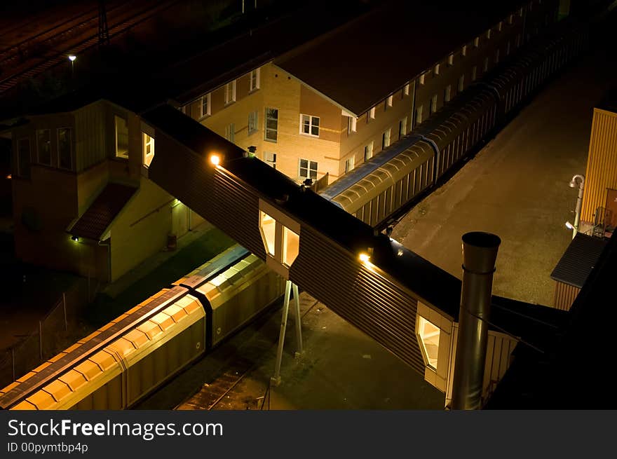 Night photo of a train at a factory building. Night photo of a train at a factory building