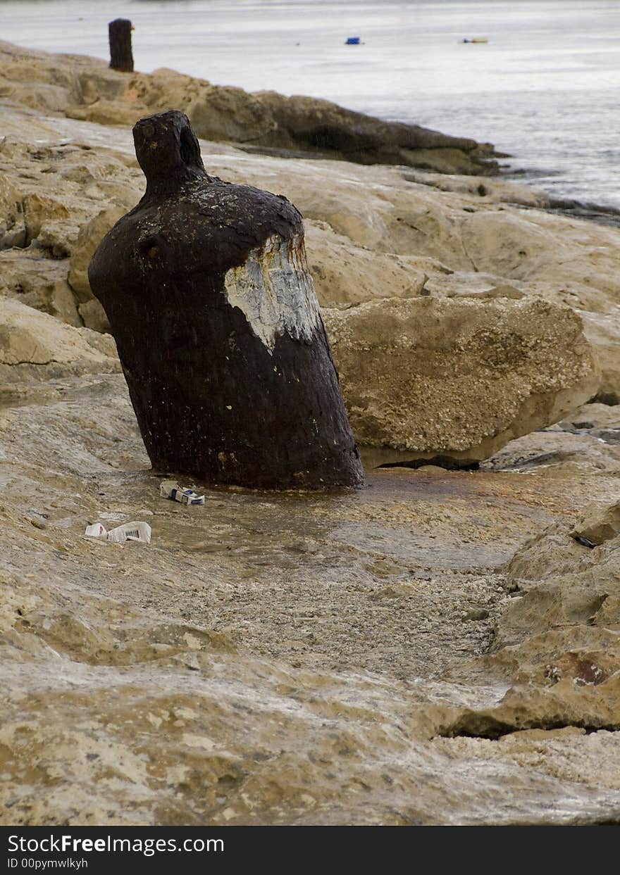 Rusty bollard on a rainy day. Rusty bollard on a rainy day