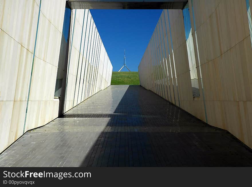 Modern construction in Canberra, australian flag on Canberra Parliament House in background