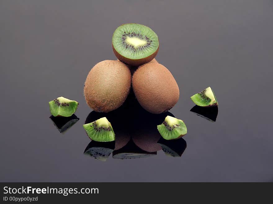 Fresh sliced kiwi on black reflective background