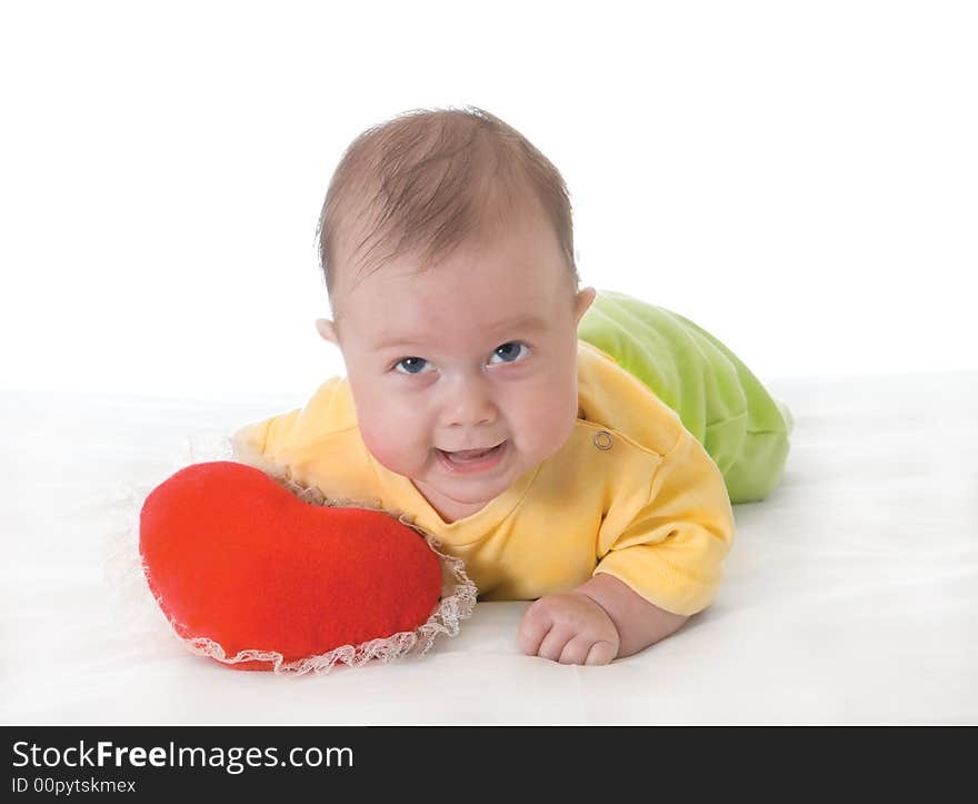 Baby with a soft toy in the form of heart over white