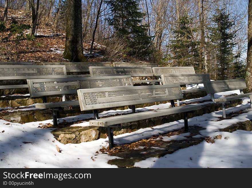 Empty seats in a snowy amphitheater area. Empty seats in a snowy amphitheater area.