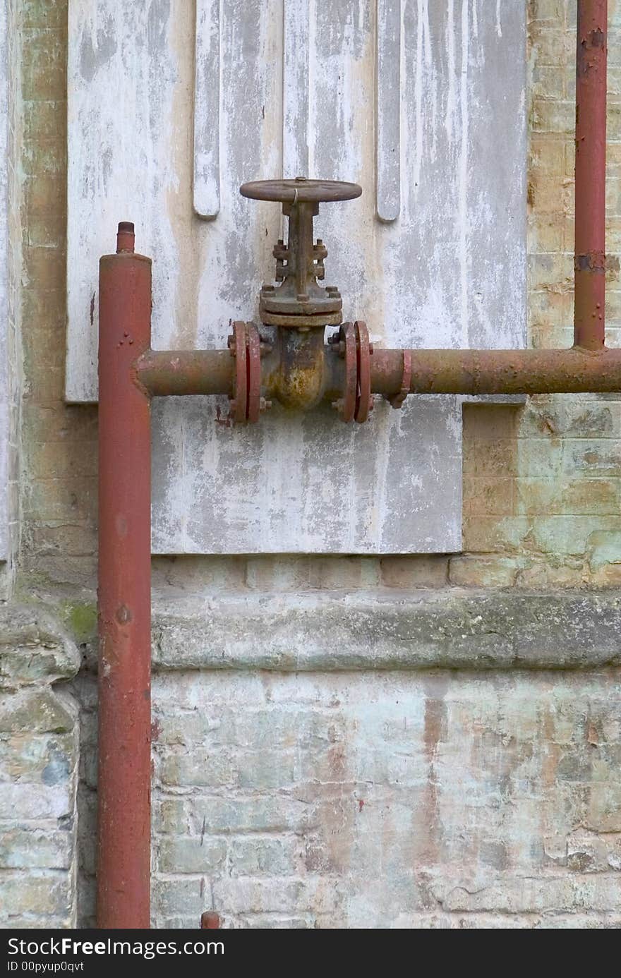 Outdoor steel, old, water valve painted red and gray